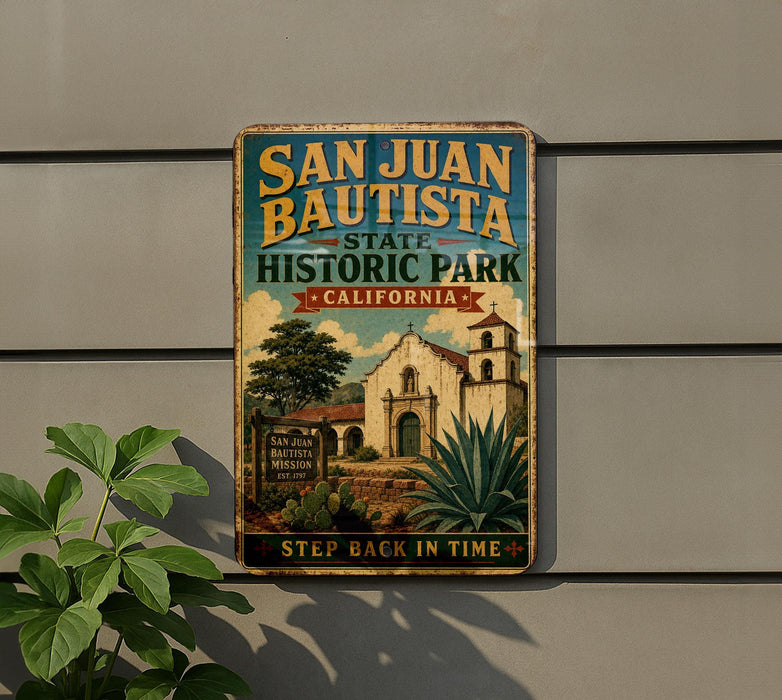 A vintage-style metal sign for San Juan Bautista State Historic Park in California, featuring an illustration of a historic building and a palm tree.