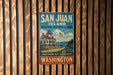 A vintage-style metal sign for San Juan Island National Historical Park in Washington, featuring a lighthouse and a scenic landscape.