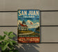A vintage-style sign for San Juan Island National Historical Park, featuring a lighthouse and a scenic landscape, mounted on a wall.