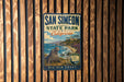 A vintage-style metal sign for San Simeon State Park in California, featuring a scenic image of a coastal landscape with a seal and the text "BIG SUR COAST".