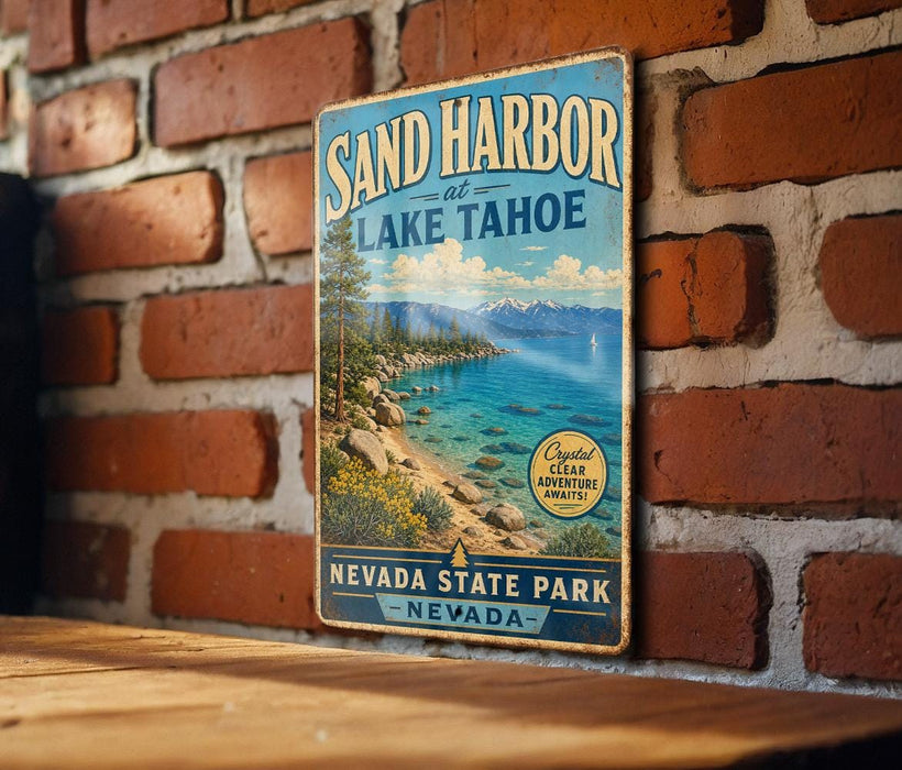 A vintage-style metal sign for Sand Harbor at Lake Tahoe, featuring a scenic landscape with mountains, water, and a clear blue sky.
