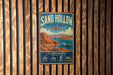A vintage metal sign for Sand Hollow State Park in Utah, featuring a scenic illustration of the park's landscape and water activities.