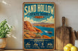 A vintage-style metal sign for Sand Hollow State Park in Utah, featuring a scenic illustration of the park's landscape with a lake, mountains, and boats.