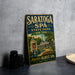 A vintage-style sign for the Saratoga Spa in New York, featuring an illustration of the spa and its surroundings.