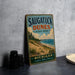 A vintage metal sign for Saugatuck Dunes State Park in Michigan, featuring a scenic beach landscape with pine trees and a body of water.