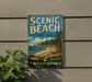 A vintage-style metal sign for Scenic Beach State Park in Washington, featuring a scenic landscape with a beach, mountains, and pine trees.