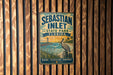 A vintage-style metal sign for Sebastian Inlet State Park in Florida, featuring a pelican and a scenic landscape.