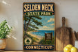 A vintage-style sign for Selden Neck State Park in Connecticut, featuring a scenic beach landscape with pine trees and a blue sky with clouds.