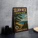 A vintage metal sign for Selden Neck State Park in Connecticut, featuring a scenic landscape with a beach, pine trees, and a blue sky with clouds.