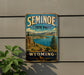 A vintage-style sign for Seminoe State Park in Wyoming, featuring a scenic landscape with mountains, a lake, and pine trees.
