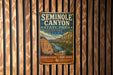 A vintage metal sign for Seminole Canyon State Park and Historic Site in Texas, featuring a scenic illustration of the canyon landscape.