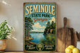 A vintage-style metal sign for Seminingo State Park in Georgia, featuring a scenic landscape with a lake, pine trees, and mountains.