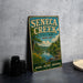 A vintage metal sign for Seneca Creek State Park in Maryland, featuring a scenic illustration of the park's natural surroundings.