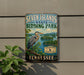 A vintage-style metal sign for Seven Islands State Birding Park in Tennessee, featuring a large blue heron in a natural setting.