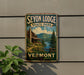 A vintage-style sign for Seyon Lodge State Park in Vermont, featuring a cabin and a scenic landscape.