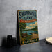 A vintage-style sign for Shabbona Lake, Illinois, featuring a scenic illustration of the lake and surrounding landscape.