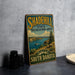 A vintage-style metal sign for the Shadehill State Recreation Area in South Dakota, featuring a scenic landscape with a lake and mountains.