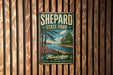 A vintage metal sign for Shepard State Park in Mississippi, featuring a scenic landscape with a lake, dock, and trees.