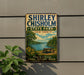 A vintage-style sign for Shirley Chisholm State Park in New York, featuring a scenic landscape with a lake, trees, and a picnic table.