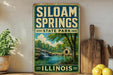 A vintage-style sign for Siloam Springs State Park in Illinois, featuring a scenic landscape with a waterfall and a small cabin.