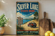 A vintage-style sign for Silver Lake State Park, featuring a red Jeep parked on a dirt road with a scenic landscape in the background.