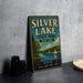 A vintage-style metal sign for Silver Lake State Park in New York, featuring a scenic illustration of a lake with a sailboat and mountains in the background.