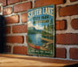A vintage-style metal sign for Silver Lake State Park in Vermont, featuring a scenic image of a lake, mountains, and a red canoe.