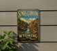 A vintage-style metal sign for Sinks Canyon State Park in Wyoming, featuring a scenic illustration of the canyon landscape with a waterfall.