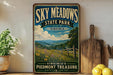 a vintage-style sign for Sky Meadows State Park in Virginia, with a scenic landscape of mountains, fields, and a wooden fence.