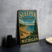 A vintage-style metal sign for Sleeper State Park, Michigan, featuring a scenic landscape with a beach, pine trees, and a lake.