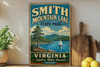 A vintage-style sign for Smith Mountain Lake State Park in Virginia, featuring a scenic illustration of a lake, mountains, and a sailboat.