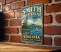 A vintage-style metal sign for Smith Mountain Lake State Park in Virginia, featuring a scenic image of a lake with a sailboat and mountains in the background.
