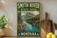 A vintage-style sign for Smith River State Park in Montana, featuring a scenic mountain landscape with a river flowing through it.