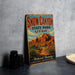 A vintage-style metal sign advertising Snow Canyon State Park in Utah, featuring a desert landscape with a mountain in the background.