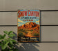 A vintage-style sign for Snow Canyon State Park in Utah, featuring a desert landscape with mountains and desert plants.