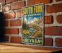 A vintage-style sign for the South Fork State Recreation Area in Nevada, featuring a scenic mountain landscape and a river.