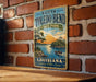 A vintage metal sign for South Toledo Bend State Park in Louisiana, featuring a scenic illustration of a lake and a boat on the water.