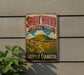 A vintage-style metal sign for Spirit Mound Historic Prairie in South Dakota, featuring a scenic landscape with a mountain, flowers, and a winding path.