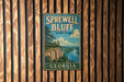 A vintage-style sign for Sprewell Bluff State Park in Georgia, featuring a scenic landscape with a river and mountains.