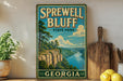 A vintage-style sign for Sprewell Bluff State Park in Georgia, featuring a scenic landscape with a river and mountains.