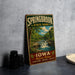 A vintage-style metal sign for Springbrook State Park in Iowa, featuring a scenic image of a waterfall and forest.