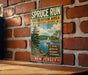 A vintage metal sign for the SPRUCE RUN Recreation Area in New Jersey, featuring a scenic illustration of a lake, pine trees, and a sailboat.