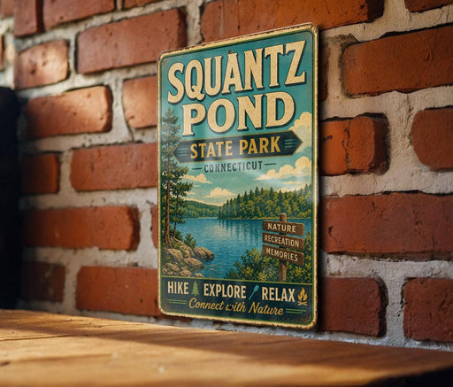 A vintage-style metal sign for Squantz Pond State Park in Connecticut, featuring a scenic image of the pond surrounded by trees and mountains.