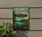 a vintage metal sign for Squantz Pond State Park in Connecticut, with a scenic landscape of a lake, trees, and mountains.