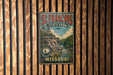 A vintage metal sign for St. Francis State Park in Missouri, featuring a scenic landscape with a river and mountains.