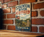 a vintage metal sign for Staunton River Battlefield State Park in Virginia, depicting a cannon and a monument.