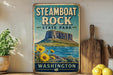 A vintage-style sign for Steamboat Rock State Park in Washington, featuring a mountain landscape with a lake and sunflowers.