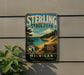A vintage metal sign for Sterling State Park, featuring a scenic landscape with a lake, mountains, and trees.