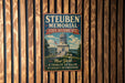A metal plaque with the text "Steuben Memorial State Historic Site" and an illustration of a building, mounted on a wooden wall.