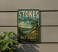 A vintage-style sign for Stokes State Forest in New Jersey, featuring a scenic landscape with pine trees and a lake.